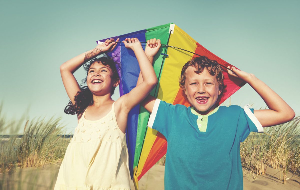 49663769 - children playing kite happiness cheerful beach summer concept